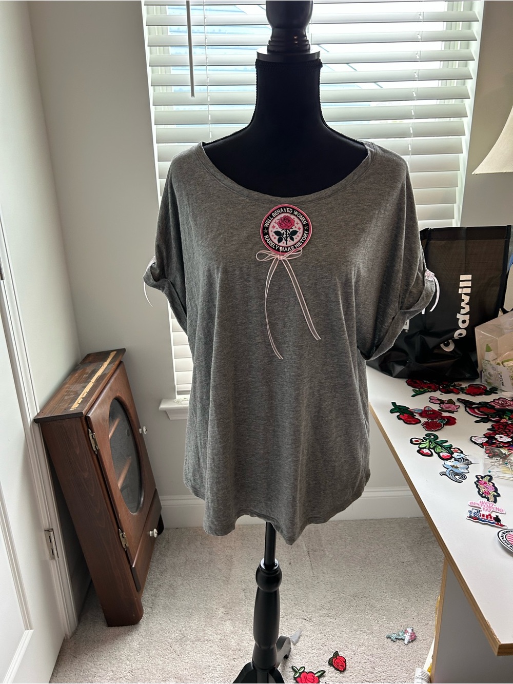 Women's Grey Short-Sleeve Scoop Neck Tee with Pink Patch Detail. Never forget.